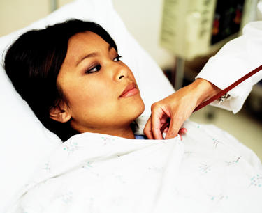 A woman having her heart rate checked.