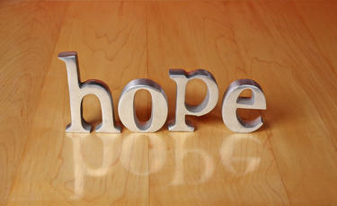 The letter HOPE on a table.