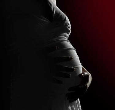 Pregnant women holding her belly.