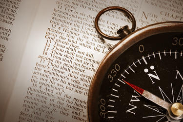 Compass on top of Bible - Showing the Ten Commandments
