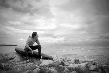 Boy on rock looking at water - If a Man Die, Will He Live Again?
