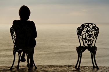 Woman and empty chair - In the Shadow of Death