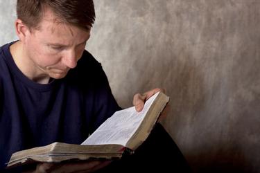 Man reading a Bible.