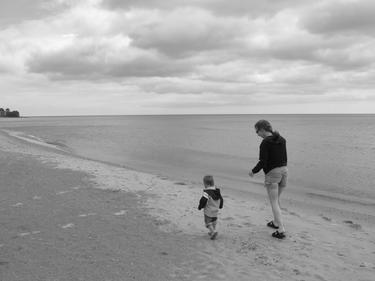 mother and son walking on beach