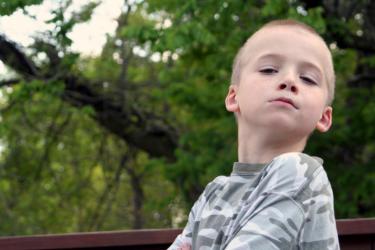 Young boy with head raised high and arms crossed - Respect: Is It a Dying Virtue