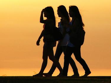 three girls walking in sunshine
