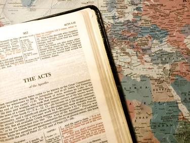 Bible opened to the book of Acts.