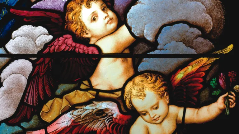 Cupid also came to be represented by the putto figures that had earlier attended to him in Classical art—now representing the presence of love. Stained glass close-up of two cherubic angels in the sky