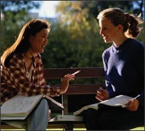 Two teenage girls talking to each other.