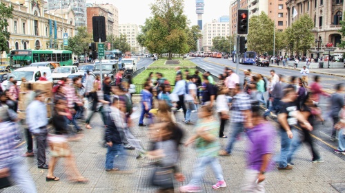 A blur of people walking in a busy city.