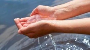 Hands holding water over more water - Understanding God's Word... What the Bible