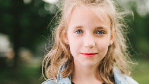 A young girl smiling.