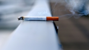 a cigarette balanced on a ledge