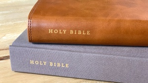 Two Bibles stacked on a table