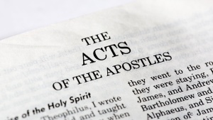 A Bible opened to the book of Acts.