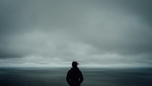 A person looking out at a body of water.