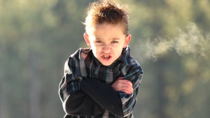 A young boy looking angry.