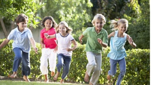 A group of young kids running.