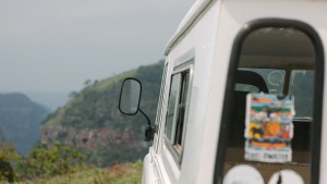 A four wheel drive vehicle with old stickers on the back window.