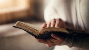 A woman holding a Bible.