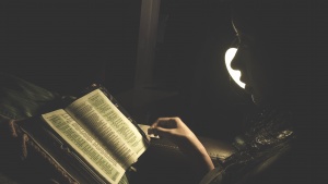 A woman reading a Bible.