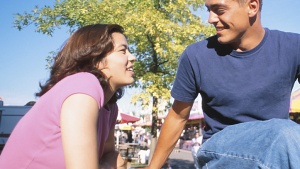 A young couple talking to each other.