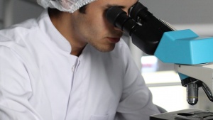 A person looking through a microscope.