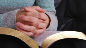 A person holding a Bible.