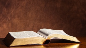An open Bible laying on a table.
