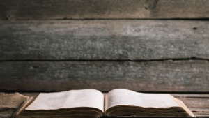 An open Bible laying on a table.