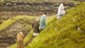 People walking up a hill.