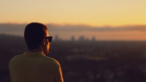 A man looking at a sunrise.