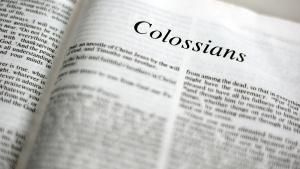 A Bible opened to book of Colossians. 