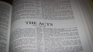 A Bible opened to the book of Acts.