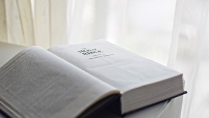 An open Bible laying on a table.