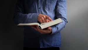 A person holding a Bible.