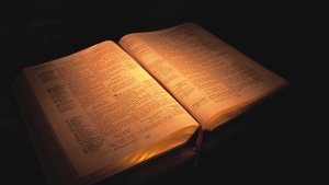 An older Bible open laying on a table.