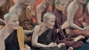 Buddhist monks sitting on the floor.