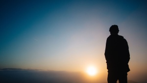 A person watching a sunset.