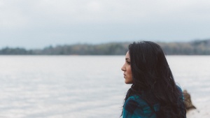 A woman looking out over a body of water.