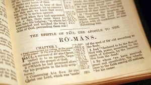 A Bible opened to the book of Romans.