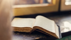 An open Bible on a windowsill.