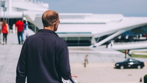 A man walking on a ramp to a building.