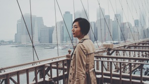 A woman walking on a bridge.