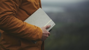 A man holding a journal notebook.