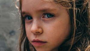 A young girl looking sad.