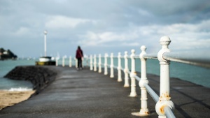 A person walking on an pier.