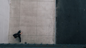 A man walking alone on a sidewalk.