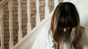 A woman with head bowed in prayer.