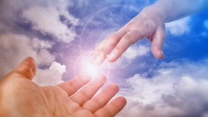 A photo illustration of hand coming out of the clouds.